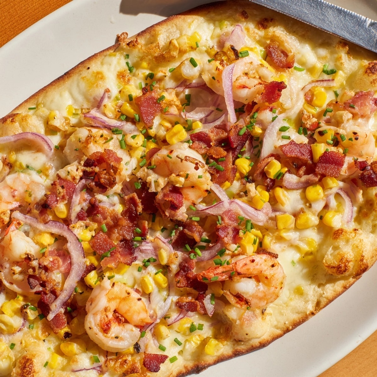 Golden Shrimp Corn Chowder Flatbread, bubbly cheese, and crisp bacon freshly baked.
