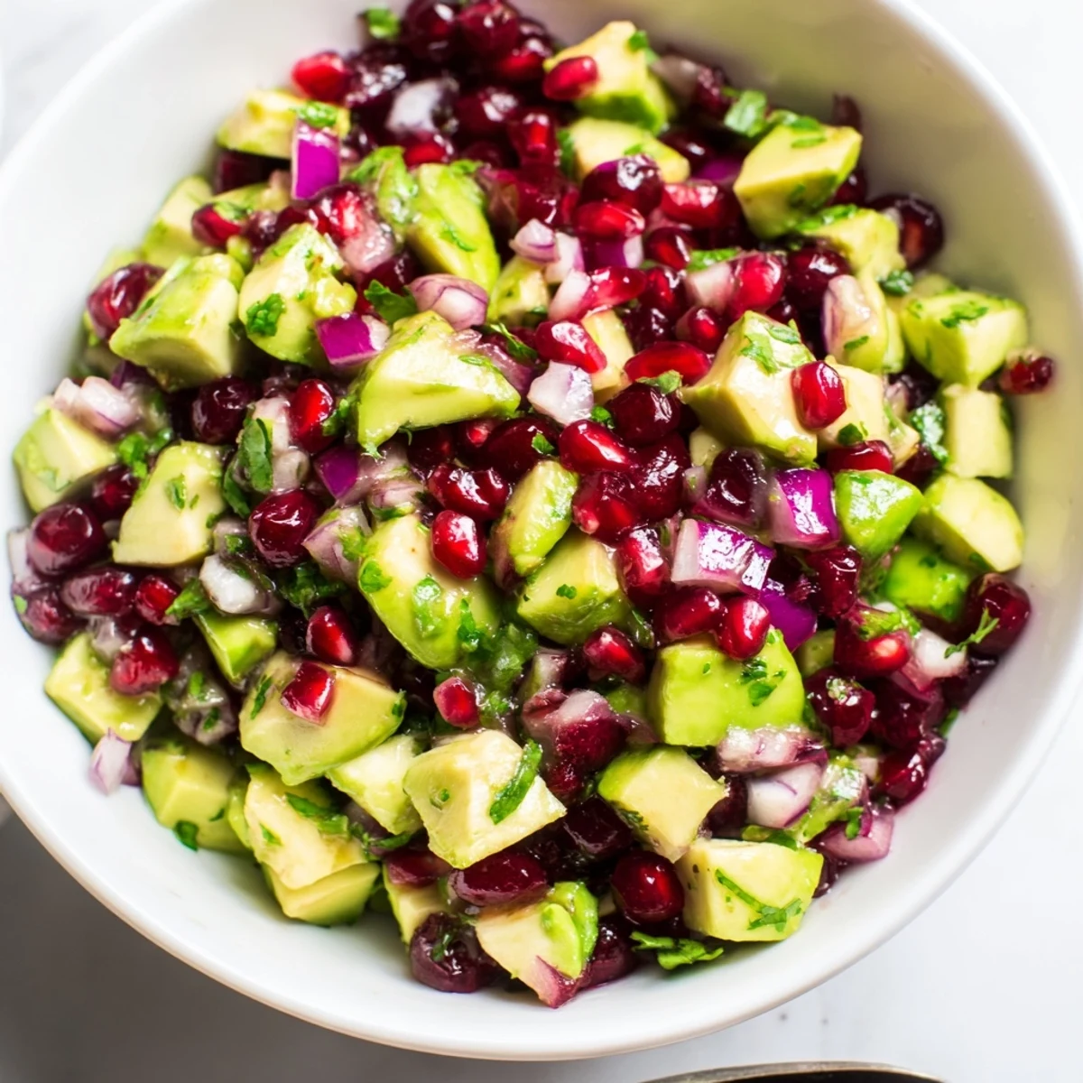 Deliciously zesty Cranberry Jalapeño Avocado Salsa as a colorful topping for grilled dishes.