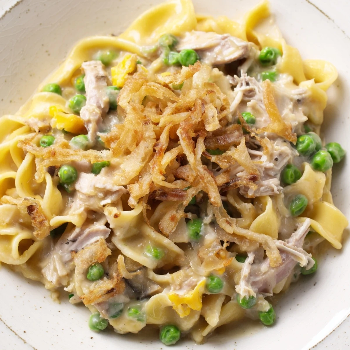 Creamy Tuna Noodle Casserole with a golden crust, steaming hot, ready for a comforting dinner.