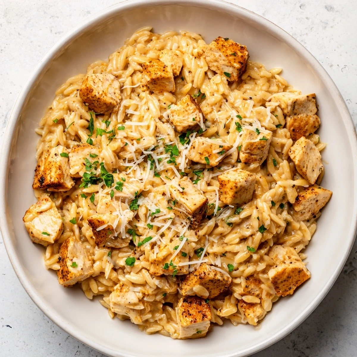One-Pot Cajun Chicken Alfredo Orzo, a creamy skillet full of tender chicken and flavorful orzo pasta.