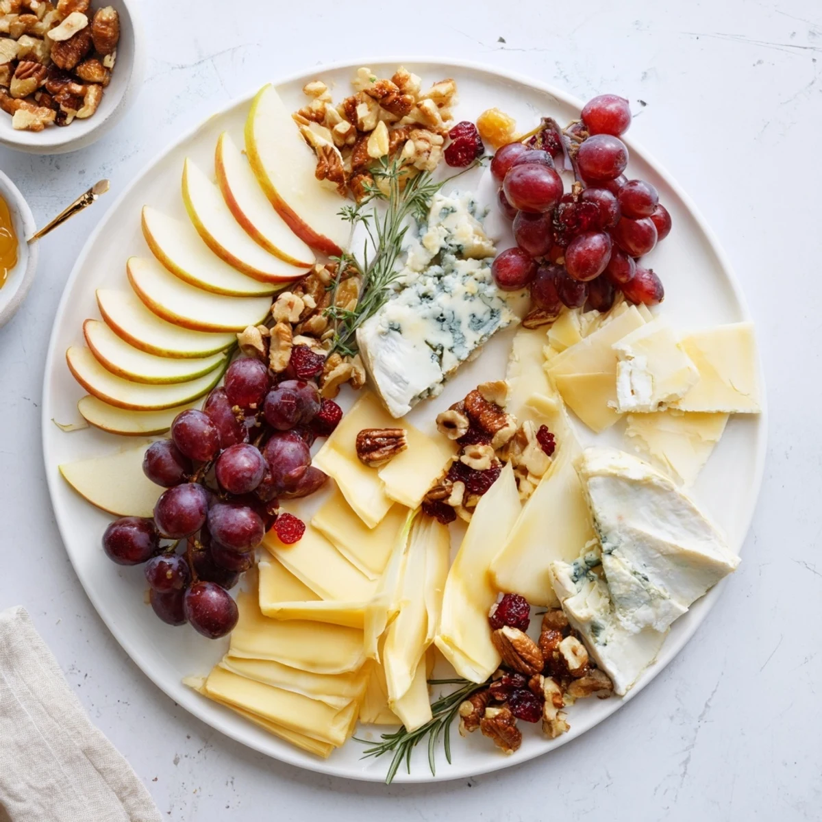 See this beautiful Winter Cabin Cheese Display platter with creamy brie, juicy grapes, and crunchy walnuts set out.