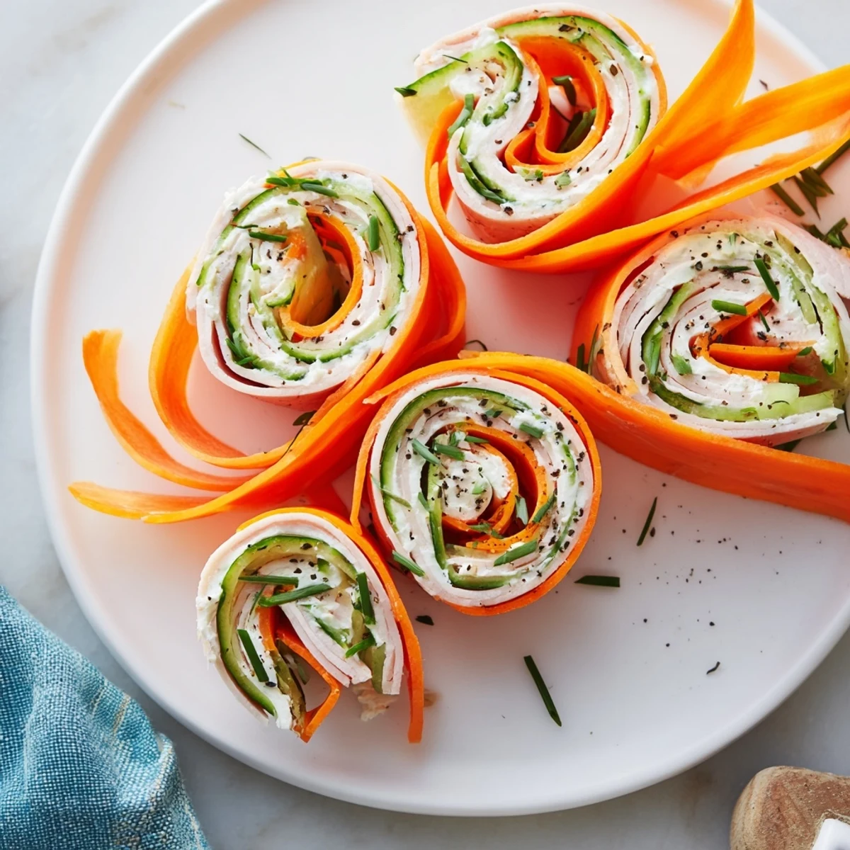 Freshly made Ribbon Dancer rolls: visual delight of spiraled veggies encircling savory turkey for snacking.