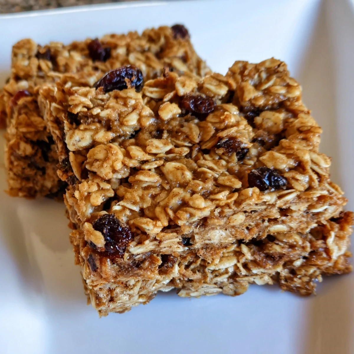 Fresh-baked maple cinnamon oatmeal bars, served on a plate ready to enjoy as a flavorful snack.