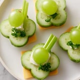 Freshly made Lucky Four-Leaf Clover Snack featuring cheese clovers, juicy grapes, and crunchy celery stems.