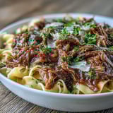 Garnished with fresh parsley and optional melted Gruyère for an extra savory finish.