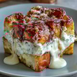 Cream Cheese Swirl Cinnamon Roll French Toast Bake with marbled cheesecake ribbons on rustic wooden table.