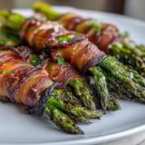 Perfectly roasted Keto Bacon-Wrapped Asparagus Bundles with Parmesan, glistening with savory drippings and golden cheese.