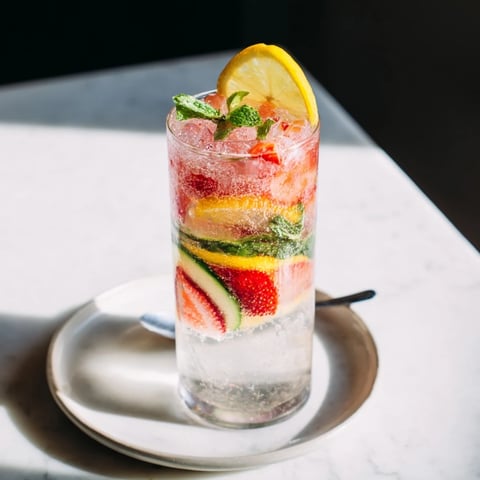 Refreshing water-based mocktails filled with fresh strawberries and mint leaves.  