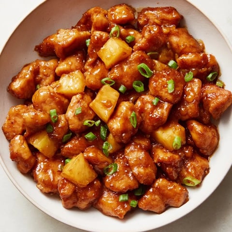 Juicy Brown Sugar Pineapple Chicken, glistening with a vibrant glaze, ready to serve alongside fluffy rice.