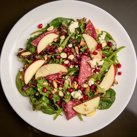 A close-up of the Hot Girl Christmas Salad, featuring colorful produce and savory hard salami ribbons.