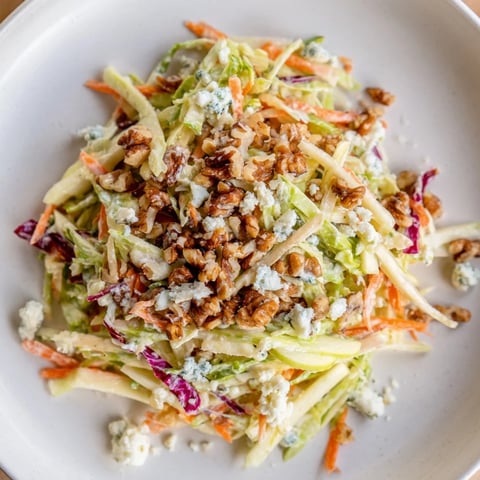 Vibrant Crunchy Apple & Walnut Slaw with Blue Cheese, tossed in a creamy dressing, ready to enjoy.