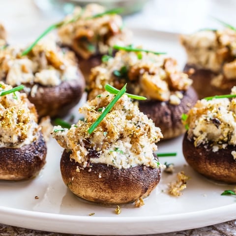 Golden-brown Stuffed Mushroom Caps arranged in a delicious ring, fantastic appetizer ready to eat.