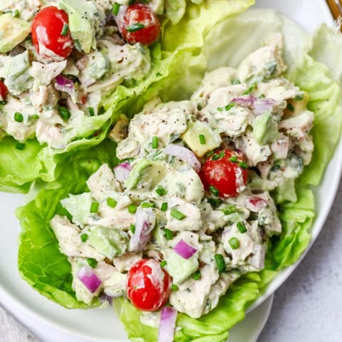 Close-up of vibrant Avocado Ranch Chicken Salad Cups, speckled with dill and chives, ready to eat.