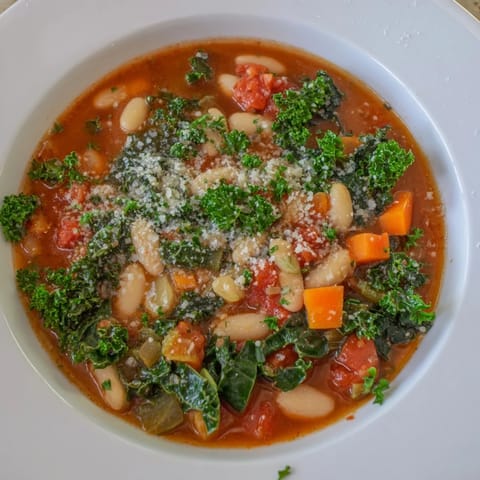 A close-up of the flavorful Italian Bean & Kale Stew, thick with beans and vegetables, ready to be enjoyed.
