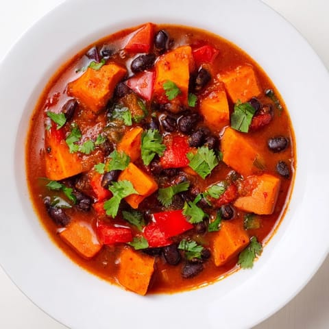 A close-up of a flavorful Sweet Potato & Black Bean Chili, perfect for a cozy dinner.