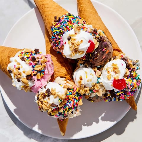 Vibrant Ice Cream Cone Grazing Board offering colorful cones and delightful sweet toppings to enjoy.