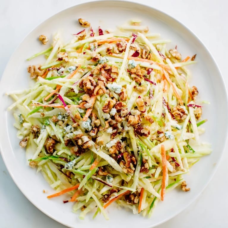 Close-up of fresh Crunchy Apple & Walnut Slaw with Blue Cheese, perfect side dish for a summer meal.