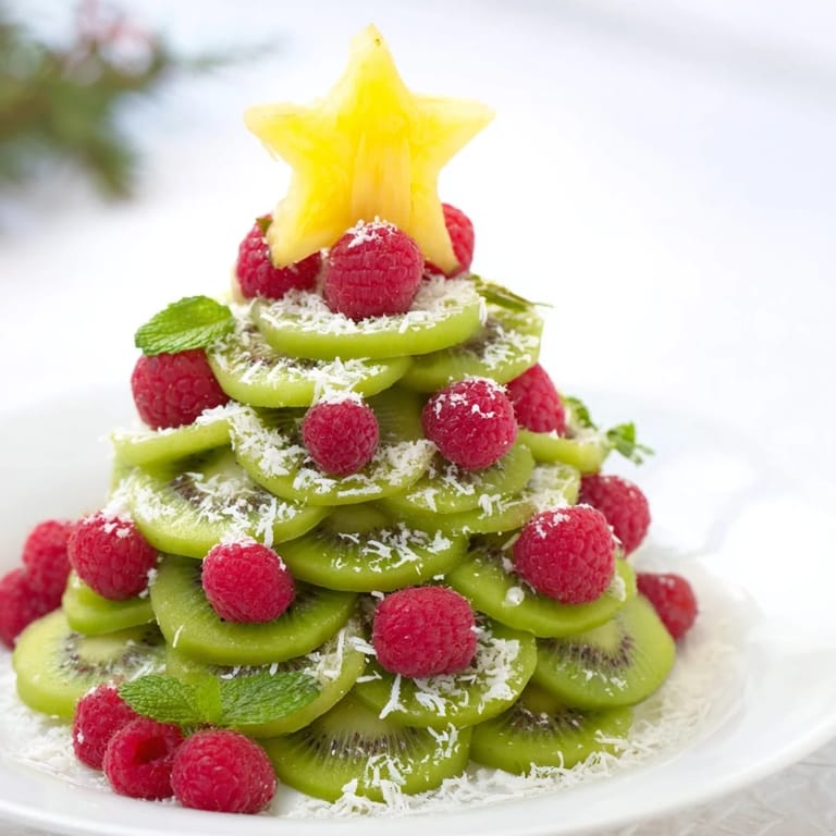 Festive Kiwi and raspberry Christmas tree platter: a refreshing, healthy holiday appetizer.