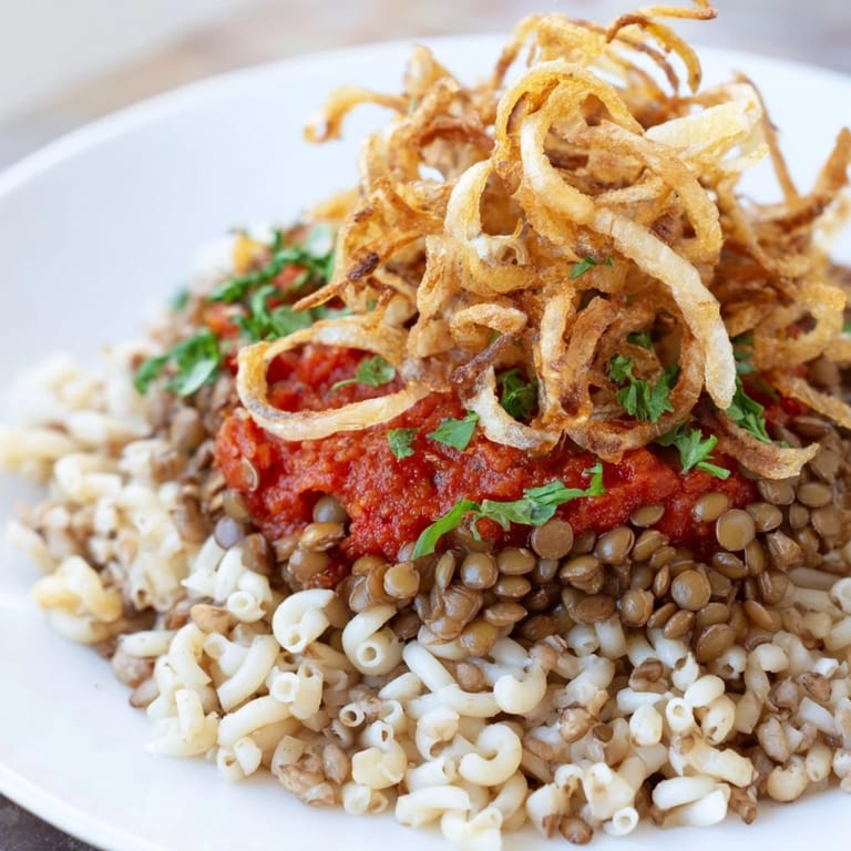 This colorful Koshari recipe showcases crispy onions adding an enticing textural contrast to the dish.